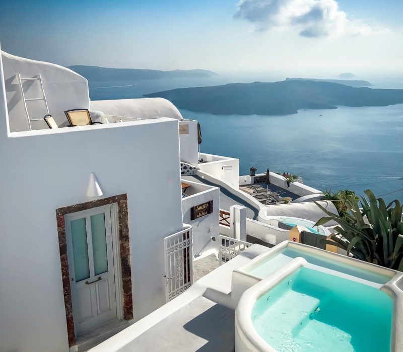 Charming Santorini scene featuring white architecture and stunning sea view.